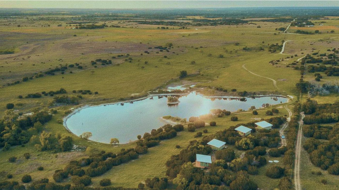 Aerial of the lake and cabins at golden hour